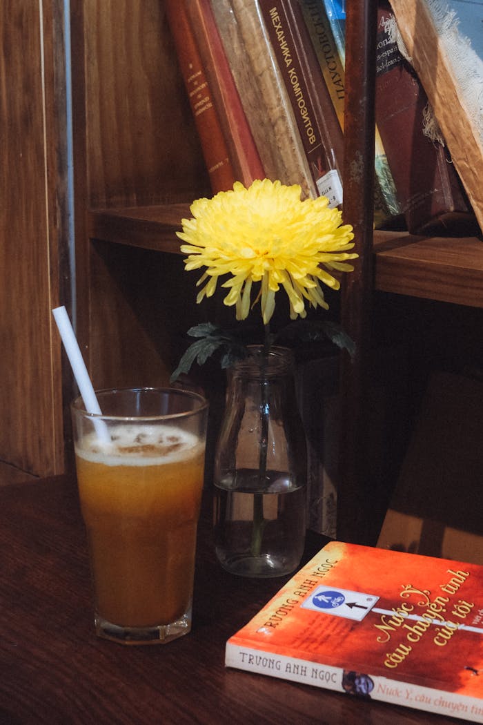 Warm reading nook in Ho Chi Minh City with a drink and books for a cozy ambiance.